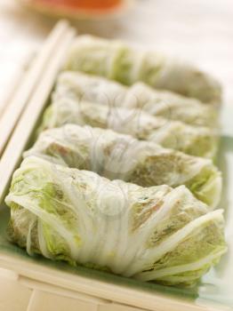 Royalty Free Photo of Steamed Pork and Vegetable Cabbage Rolls With Sweet Chili Sauce