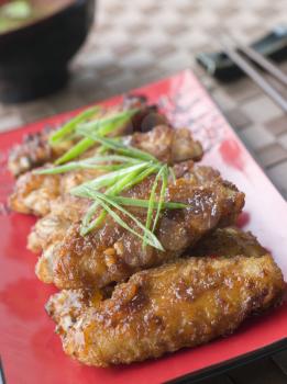 Royalty Free Photo of Sweet Spicy Chicken Wings and Sukiyaki Sauce