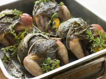 Royalty Free Photo of Quails Roasted in Vine Leaves with Lemon and Thyme