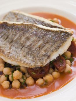 Royalty Free Photo of Fillets of Sea Bream With Chorizo Sausage Chickpeas and Tomato Sauce