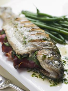 Royalty Free Photo of a Whole River Trout with Jamon and Herb Butter