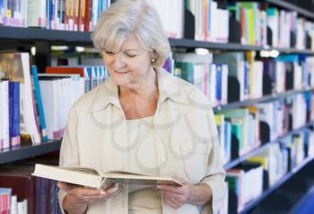 Royalty Free Photo of a Woman Reading in a Library