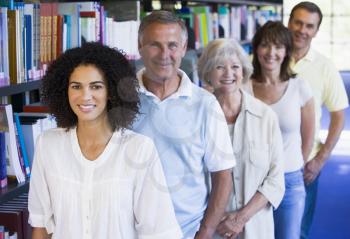 Royalty Free Photo of a Group of People Standing in a Library