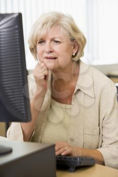 Royalty Free Photo of a Woman Frowning at a Computer