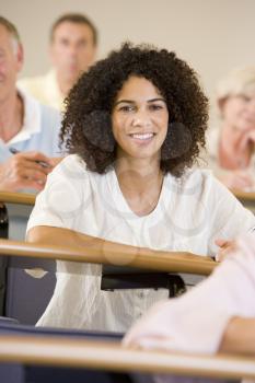 Royalty Free Photo of a Woman at a Desk in a Classroom