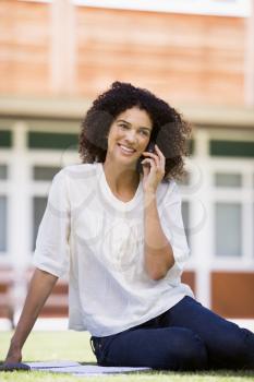 Royalty Free Photo of a Woman on a Lawn Talking on a Cellphone