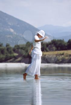 Royalty Free Photo of a Woman Walking in Shallow Water