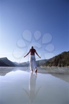 Royalty Free Photo of a Woman Walking in Shallow Water