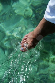 Royalty Free Photo of a Woman's Foot in the Water