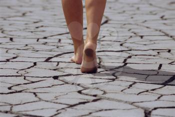 Royalty Free Photo of a Women's Feet on Cracked Earth