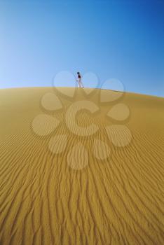 Royalty Free Photo of a Woman Walking in a Desert