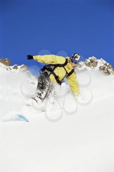Royalty Free Photo of a Snowboarder Coming Down a Hill