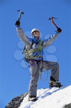 Royalty Free Photo of a Mountain Climber at the Top