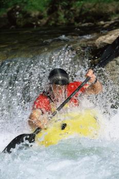 Royalty Free Photo of a Kayaker Coming Down a Small Waterfall