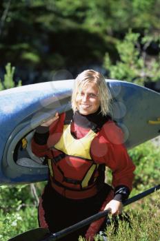 Royalty Free Photo of a Woman Portaging With a Kayak