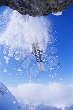 Royalty Free Photo of a Skier Coming Off a Snowy Cliff
