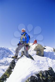 Royalty Free Photo of a Mountain Climbing Team on Top of a Mountain