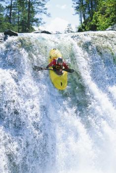 Royalty Free Photo of a Kayaker Coming Over Falls
