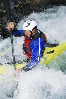 Royalty Free Photo of a Kayaker in Rapids