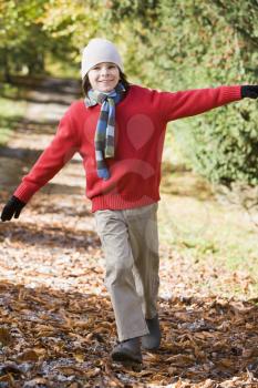Royalty Free Photo of a Young Boy Running on a Trail