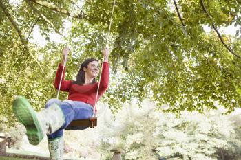 Royalty Free Photo of a Woman Swinging