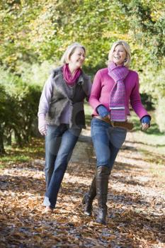 Royalty Free Photo of a Mother and Adult Daughter Walking on a Trail