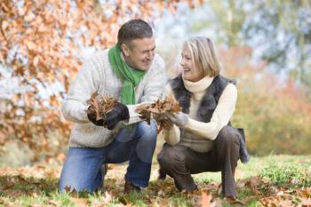 Royalty Free Photo of a Couple Holding Leaves
