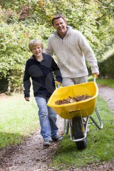 Royalty Free Photo of a Father and Son With a Wheelbarrow