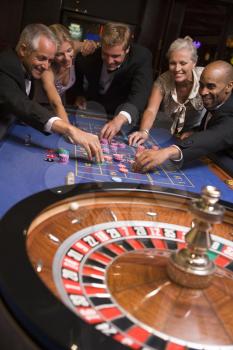 Royalty Free Photo of a People Around a Roulette Table