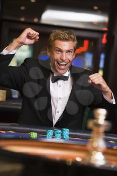 Royalty Free Photo of a Man Winning at a Roulette Table