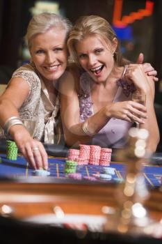 Royalty Free Photo of Two Women at a Roulette Table