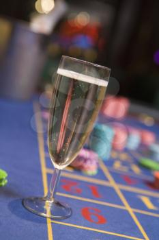 Royalty Free Photo of a Champagne Flute on a Roulette Table