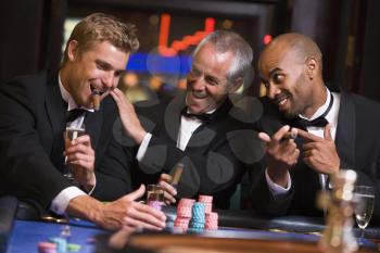 Royalty Free Photo of Three Men at a Roulette Table