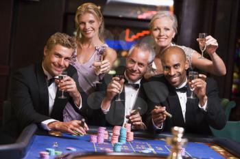 Royalty Free Photo of Five People at a Roulette Table