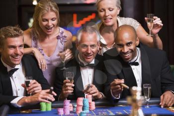 Royalty Free Photo of Five People at a Roulette Table