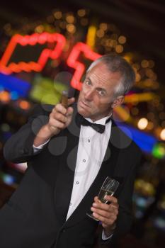 Royalty Free Photo of a Man at a Casino With a Champagne Glass and Cigar