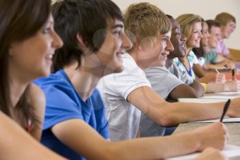 Royalty Free Photo of Smiling Students Taking Notes