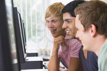 Royalty Free Photo of Three Male Students at a Computer