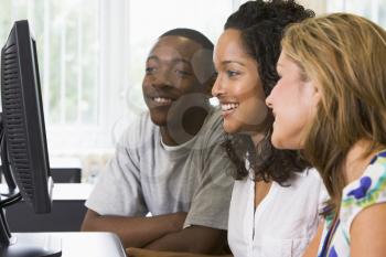 Royalty Free Photo of Three People at a Computer
