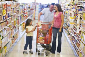 Royalty Free Photo of a Couple Shopping With Their Daughter