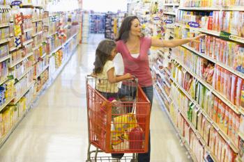 Royalty Free Photo of a Mother and Daughter Shopping for Groceries
