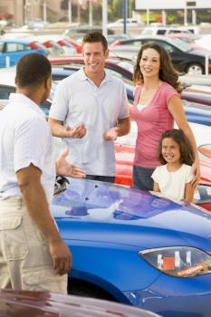 Royalty Free Photo of a Family Shopping for a Car