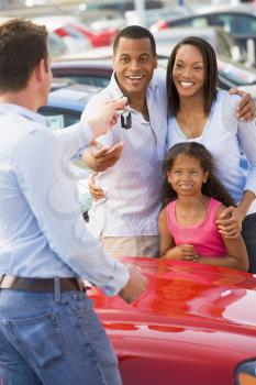 Royalty Free Photo of a Family Picking Up a New Car
