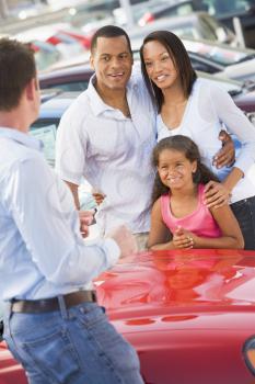 Royalty Free Photo of a Family Getting Their New Car