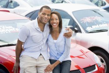 Royalty Free Photo of a Young Couple Buying a Car