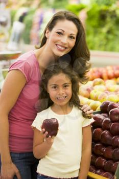 Royalty Free Photo of a Mother and Daughter Shopping for Apples