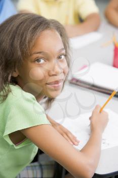 Royalty Free Photo of a Girl Writing in Class