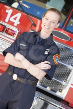 Royalty Free Photo of a Female Firefighter in Front of the Truck