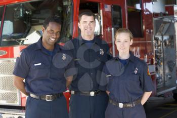 Royalty Free Photo of Three Fighters Beside the Firetruck