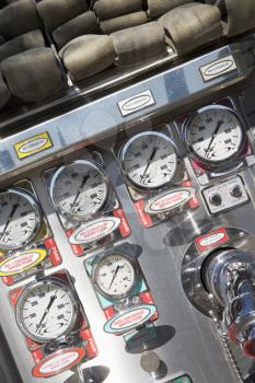 Royalty Free Photo of Fire Hoses and Pressure Gauges in a Firetruck